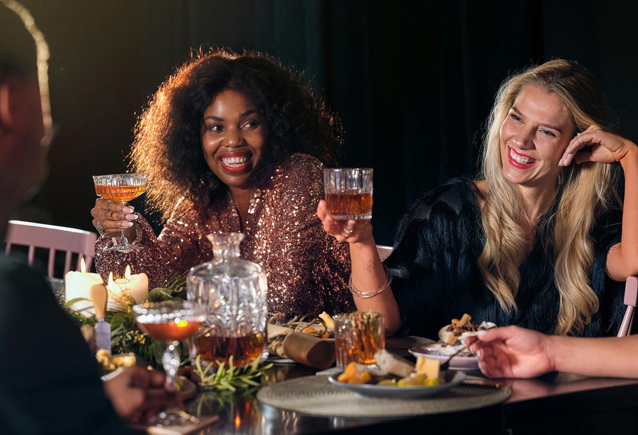Women celebrating with drinks at a Christmas party meal